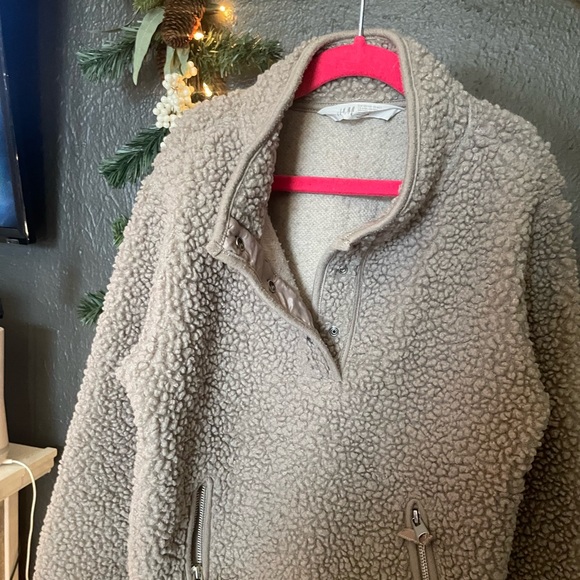 A warm unisex tan-ish brown pullover sweater with two front zipper pockets. - Picture 3 of 4